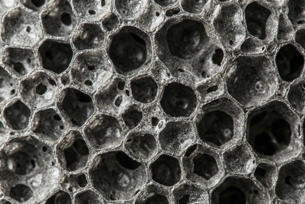 Macro shot of the cellular texture of the Fur-Zoff stone, resembling natural volcanic pumice.
